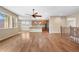 Spacious living room featuring hardwood floors, large windows, and a ceiling fan at 3995 Manorbrier Cir, Castle Rock, CO 80104
