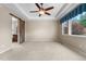 Spacious main bedroom offers a ceiling fan, plush carpet, and a barn door to ensuite at 3995 Manorbrier Cir, Castle Rock, CO 80104