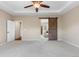 Inviting main bedroom features plush carpet, ceiling fan, and access to the ensuite at 3995 Manorbrier Cir, Castle Rock, CO 80104