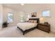 Bright bedroom with a comfortable king bed, bedside tables, and three large windows, offering ample natural light at 2525 S Pearl St, Denver, CO 80210