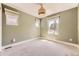 This cozy bedroom features green walls, carpet flooring, and three windows offering natural light at 2525 S Pearl St, Denver, CO 80210