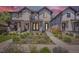 Charming modern home boasts beautiful landscaping, a stone porch, and a delightful exterior design at 2525 S Pearl St, Denver, CO 80210