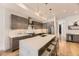 Modern kitchen with a large quartz island, stainless steel appliances, and wood cabinets at 2525 S Pearl St, Denver, CO 80210