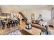 Open-concept living space with hardwood floors, modern decor, and an open staircase at 2525 S Pearl St, Denver, CO 80210