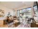 Bright living room with leather couch and large windows with a walk-out patio at 2525 S Pearl St, Denver, CO 80210
