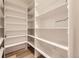 Spacious walk-in pantry boasts custom white shelving and sleek hardwood floors at 2525 S Pearl St, Denver, CO 80210