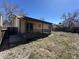 Backyard of home has a wooden deck, small fence and trees at 3577 S Ouray Cir, Aurora, CO 80013