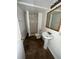 Cozy bathroom features a pedestal sink, tiled shower, and neutral color scheme at 3577 S Ouray Cir, Aurora, CO 80013