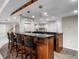 Gorgeous basement bar with pendant lighting and seating for several guests at 21548 E Ottawa Cir, Aurora, CO 80016