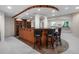 Basement bar boasts wood cabinets, seating for four, and great recessed lighting at 21548 E Ottawa Cir, Aurora, CO 80016