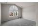 Carpeted bedroom with arched window and overhead lighting at 21548 E Ottawa Cir, Aurora, CO 80016