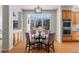 Cozy dining area featuring a round glass table, chairs, and natural light. View to outdoor grill at 21548 E Ottawa Cir, Aurora, CO 80016