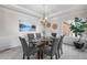 Dining room with a glass table, grey chairs, and an elegant chandelier at 21548 E Ottawa Cir, Aurora, CO 80016