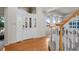 Inviting foyer with hardwood floors, a staircase with carpet runner, and a decorative front door with sidelights at 21548 E Ottawa Cir, Aurora, CO 80016