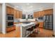 Modern kitchen with a center island, stainless steel appliances, and ample cabinetry with recessed lighting at 21548 E Ottawa Cir, Aurora, CO 80016