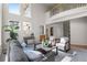 Spacious living room with tall windows, a balcony, comfortable seating, and modern decor at 21548 E Ottawa Cir, Aurora, CO 80016