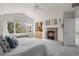 Spacious main bedroom boasts a cozy fireplace and view of the outside at 21548 E Ottawa Cir, Aurora, CO 80016