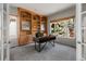 Bright office with built-in bookshelves and a large window at 21548 E Ottawa Cir, Aurora, CO 80016