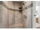 Tiled walk-in shower features a corner seat and neutral colors at 21548 E Ottawa Cir, Aurora, CO 80016