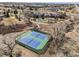 Aerial view of two tennis courts offering recreational opportunities within the community, surrounded by mature trees at 21548 E Ottawa Cir, Aurora, CO 80016