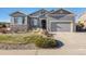 Gray two-story house with stone accents and a two-car garage at 3153 Eagle Claw Pl, Castle Rock, CO 80108