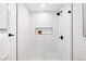 Modern shower stall featuring white subway tile, glass doors, and sleek black fixtures at 3926 Kalamath St, Denver, CO 80211