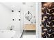 Stylish bathroom featuring glass shower with black fixtures, a soaking tub, and decorative wallpaper at 3926 Kalamath St, Denver, CO 80211