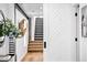 Stylish hallway with wood floors, decorative accents, and view of modern staircase at 3926 Kalamath St, Denver, CO 80211