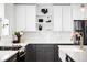 Contemporary kitchen features white backsplash, modern cabinets, and a stainless steel refrigerator at 3926 Kalamath St, Denver, CO 80211