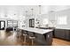 Modern kitchen boasts a large island with seating, stylish pendant lights, and stainless steel appliances at 3926 Kalamath St, Denver, CO 80211