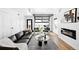 Open-concept living room with a comfortable sofa, fireplace, and lots of natural light at 3926 Kalamath St, Denver, CO 80211