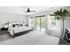 Bright main bedroom featuring soft carpet, a ceiling fan, and large sliding glass doors to the balcony at 3926 Kalamath St, Denver, CO 80211