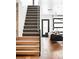 Modern staircase with wood and painted steps leading to a bright living area at 3926 Kalamath St, Denver, CO 80211
