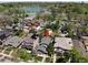 Aerial view of a house with solar panels, mature landscaping, and a lake in the background at 726 S Corona St, Denver, CO 80209