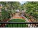 View from balcony of backyard featuring lush greenery and a stone path at 726 S Corona St, Denver, CO 80209