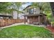 Spacious backyard with lush lawn, privacy fence, and patio area at 726 S Corona St, Denver, CO 80209