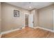 Bedroom featuring hardwood floors, baseboard trim and an open door to another room at 726 S Corona St, Denver, CO 80209