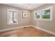 Bright bedroom featuring hardwood floors, neutral walls, and large windows at 726 S Corona St, Denver, CO 80209