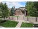 Charming brick two-story home with a well-manicured lawn and a concrete retaining wall at 726 S Corona St, Denver, CO 80209