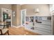 Upstairs hallway with hardwood floors, built-in shelving, and a view into the bedroom at 726 S Corona St, Denver, CO 80209