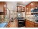 Well-lit kitchen featuring granite countertops and updated appliances and a view into the breakfast nook at 726 S Corona St, Denver, CO 80209