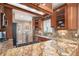Bright kitchen with granite countertops, wooden cabinets, and stainless steel appliances at 726 S Corona St, Denver, CO 80209