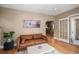 Comfortable living room with hardwood floors, a leather sofa, and an open doorway at 726 S Corona St, Denver, CO 80209