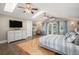 Bright primary bedroom featuring a private balcony, light-colored wood floors, and a stylish ceiling fan at 726 S Corona St, Denver, CO 80209