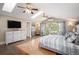 Bright primary bedroom featuring a private balcony, light-colored wood floors, and a stylish ceiling fan at 726 S Corona St, Denver, CO 80209