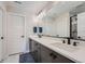 Modern bathroom featuring double sinks with matte black fixtures, a large mirror, and sleek vanity with ample storage at 16433 Askins Loop, Parker, CO 80134