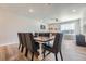Inviting dining room with seating for eight, hardwood floors, and a view into the adjacent living area at 16433 Askins Loop, Parker, CO 80134
