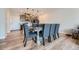 Charming dining room with a large table, chairs, and modern lighting in a well-lit space with hardwood floors at 16433 Askins Loop, Parker, CO 80134