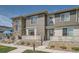 Townhome exteriors with stone accents, contemporary siding, and cozy patios at 16433 Askins Loop, Parker, CO 80134