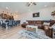 Inviting living room with an oversized sectional sofa and an open view to the modern kitchen at 16433 Askins Loop, Parker, CO 80134